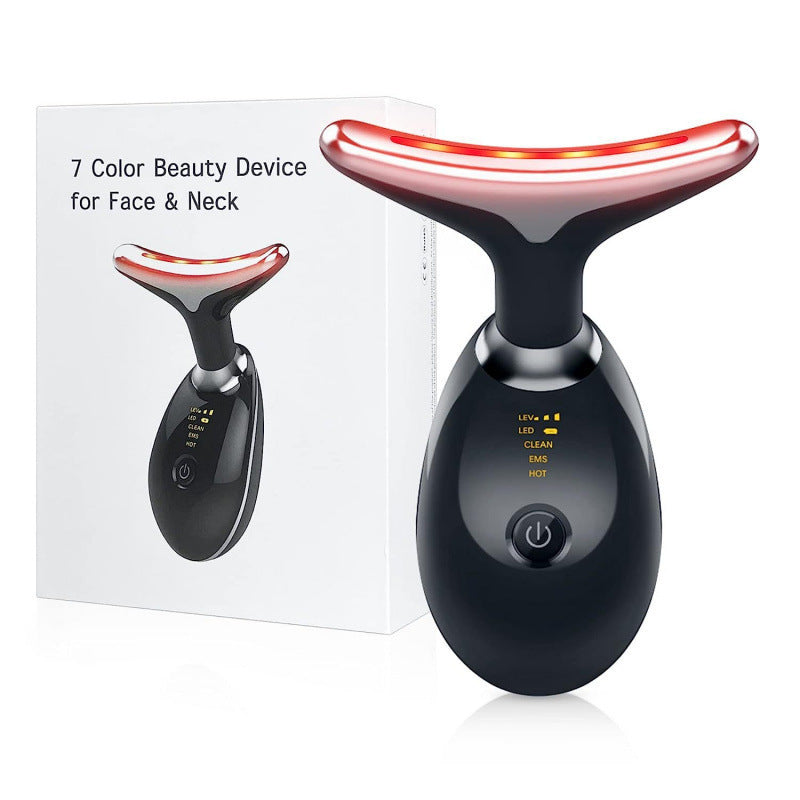 Black neck and face massager next to its gift box